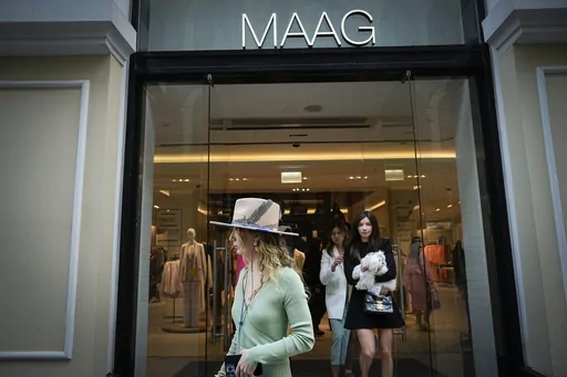 A woman exits a newly opened Maag store, a former Zara flagship store, in Moscow, Russia, Thursday, April 27, 2023. When Russia invaded Ukraine, companies were quick to respond, some announcing they would get out of Russia immediately, others vowed to curtail sales and new investment. More than a year later, it’s clear: Leaving Russia isn't as easy as the first announcements might have made it seem. (AP Photo/Alexander Zemlianichenko, File)