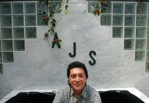 In this June 19, 2004 photo Alec John Such, of Colts Neck, N.J., sits for a portrait inside his second floor bathtub. Alec John Such, the bassist and a founding member of Bon Jovi, has died. He was 70. The band announced Sunday, June 5, 2022 that John Such died. No details on when or how John Such died were immediately available. (M. Kathleen Kelly/NJ Advance Media via AP)