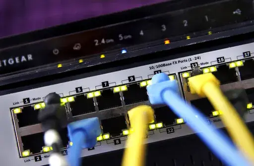A home router and internet switch are displayed on June 19, 2018, in East Derry, N.H. Telecommunications industry groups on Wednesday, May 4, 2022, ended their bid to block California's net neutrality law that prevents broadband providers from throttling service. In a federal court filing in Sacramento, the groups and California Attorney General Rob Bonta jointly agreed to dismiss the case. (AP Photo/Charles Krupa, File)