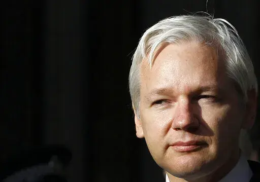 WikiLeaks founder Julian Assange pauses as he makes a statement to media gathered outside the High Court in London, on Monday, Dec. 5, 2011. The British government on Friday, June 17, 2022 ordered the extradition of WikiLeaks founder Julian Assange to the United States to face spying charges. He is likely to appeal. (AP Photo/Kirsty Wigglesworth, File)