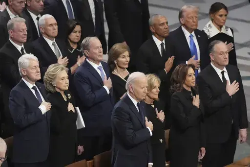 Front row, from left, President Joe Biden, first lady Jill Biden, Vice President Kamala Harris and second gentleman Doug Emhoff and second row from left, former President Bill Clinton, former Secretary of State Hillary Clinton, former President George W. Bush, Laura Bush, former President Barack Obama, President-elect Donald Trump and Melania Trump, stand during the state funeral for former President Jimmy Carter at Washington National Cathedral in Washington, Thursday, Jan. 9, 2025. (AP Photo/J