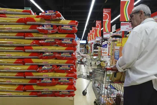 Customers look at packages of pasta on sale in a supermarket in Milan, northern Italy, on June 8, 2023. Italians can celebrate lower pasta prices but must face higher prices across the board for fruit and vegetables. Italy’s industry ministry reported last week that prices of pasta had fallen by an average of 0.3% in May compared with a month earlier, saying that a monitoring system it set up had the intended effect of reducing prices. (AP Photo/Luca Bruno, File)