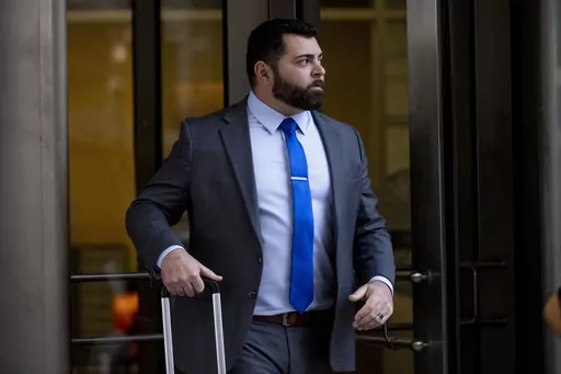 Roberto Minuta of Prosper, Texas, leaves federal court in Washington, Jan. 23, 2023. Minuta, a member of the far-right Oath Keepers extremist group who was part of a security detail for former President Donald Trump's longtime adviser Roger Stone before storming the U.S. Capitol, was sentenced on Thursday to more than four years in prison. (AP Photo/Andrew Harnik, File)