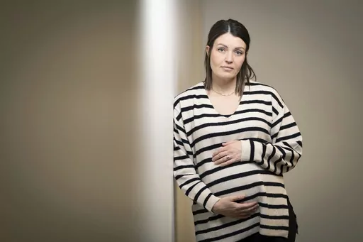 Jillaine St.Michel stands for a portrait in Boise, Idaho on Saturday, Dec. 2, 2023. A year earlier, she learned that her previous 20-week fetus had multiple genetic and developmental problems and probably wouldn’t survive. She lives in Idaho, which has a ban on abortions, so St.Michel and her husband called about 15 out-of-state clinics, finally getting on a three-week waiting list in Denver and a two-week waiting list in Seattle. Pregnant again, she is due to give birth to a boy in January. (