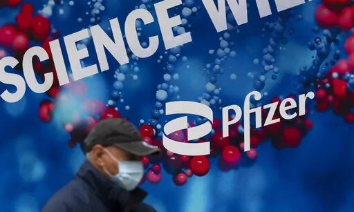 A man walks by Pfizer headquarters, Friday, Feb. 5, 2021 in New York. On Friday, May 27, 2022 The Associated Press reported on stories circulating online incorrectly claiming Pfizer received FDA approval for a new monkeypox shot the day after the U.S. purchased millions of dollars worth of vaccine for the disease. (AP Photo/Mark Lennihan)