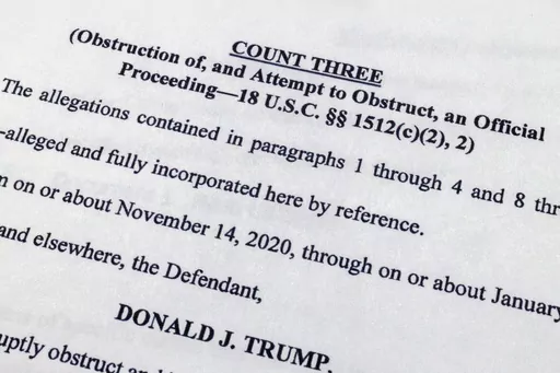 The indictment against former President Donald Trump charging him by the Justice Department for his efforts to overturn the results of the 2020 presidential election is photographed Tuesday, Aug. 1, 2023, in Washington. (AP Photo/Jon Elswick)