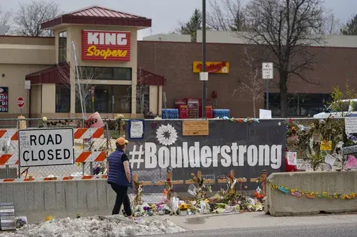 Tributes cover the temporary fence around the King Soopers grocery store in which 10 people died in a mass shooting in late March on Friday, April 23, 2021, in Boulder, Colo. (AP Photo/David Zalubowski, File)