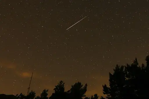 In this long exposure photo, a streak appears in the sky during the annual Perseid meteor shower at the Guadarrama mountains, near Madrid, in the early hours of Aug. 12, 2016. (AP Photo/Francisco Seco, File)