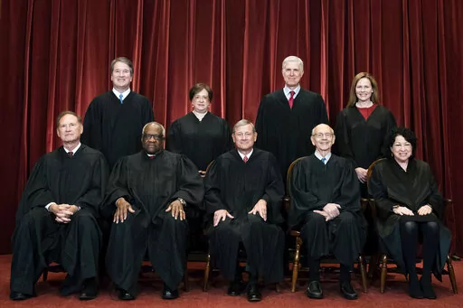 Members of the Supreme Court pose for a group photo at the Supreme Court in Washington, April 23, 2021. Seated from left are Associate Justice Samuel Alito, Associate Justice Clarence Thomas, Chief Justice John Roberts, Associate Justice Stephen Breyer and Associate Justice Sonia Sotomayor, Standing from left are Associate Justice Brett Kavanaugh, Associate Justice Elena Kagan, Associate Justice Neil Gorsuch and Associate Justice Amy Coney Barrett. The Supreme Court is refusing to say whether th