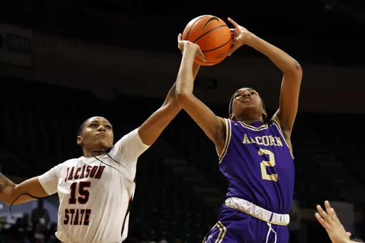 Jackson State guard Angel Jackson (15) blocks a shot-attempt by Alcorn State guard Nakia Cheatham (2) during the first half of an NCAA college basketball game in the championship of the Southwestern Athletic Conference tournament, Saturday, March 16, 2024, in Birmingham, Ala. (AP Photo/ Butch Dill)