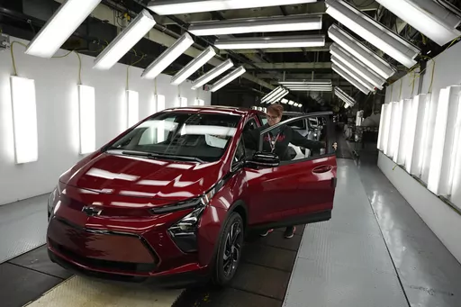 Assembly line worker Janice DeBono looks over a 2023 Chevrolet Bolt EUV at the General Motors Orion Assembly, June 15, 2023, in Lake Orion, Mich. Government tallies show only 11 of the more than 50 EVs on sale in the U.S. are eligible for tax credits so far this year. Still qualifying for credits are the Tesla Model Y SUV, Chevrolet Bolt compact car and Rivian R1T pickup truck. (AP Photo/Carlos Osorio, File)