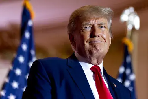 Former President Donald Trump announces he is running for president for the third time as he smiles while speaking at Mar-a-Lago in Palm Beach, Fla., Nov. 15, 2022. A Florida Judge sanctioned Trump and one of his attorneys Thursday, Jan. 19, ordering them to pay nearly $1 million for filing what he said was a bogus lawsuit against Trump's 2016 rival Hillary Clinton and others. (AP Photo/Andrew Harnik, File)