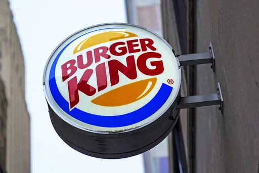 The Burger King logo is displayed on a sign outside a restaurant in downtown Pittsburgh, Jan. 12, 2022. Food ads have long made their subjects look bigger, juicier and crispier than they are in person. But some consumers say those mouthwatering ads can cross the line into deception, and that’s leading to a growing number of lawsuits. Burger King is the latest company in the crosshairs. (AP Photo/Gene J. Puskar, File)