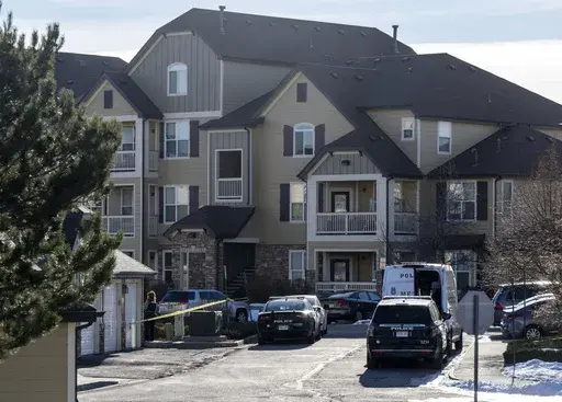 Colorado Springs Police Department investigators and officers work on the scene of a burglary that resulted in the deaths of two people at the Palomino Ranch apartment complex on Tuesday, Dec. 19, 2023 in Colorado Springs, Colo. (Parker Seibold/The Gazette via AP)