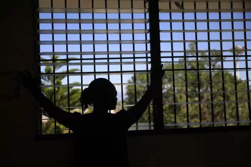 A woman who did not want to give her name for fear of retaliation poses for a photo during an interview at a clinic near Port-au-Prince, Haiti, Friday, Jan. 20, 2023. The 36-year-old sent her two children to live with family in another part of the city after her husband was kidnapped and killed. Later, the men gang-raped her and forced her to flee her home. (AP Photo/Odelyn Joseph)