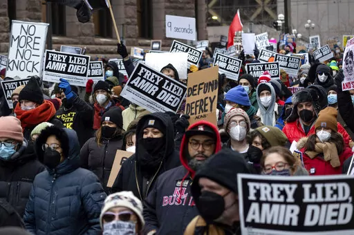 People march at a rally for Amir Locke on Saturday, Feb. 5, 2022, in Minneapolis. Minnesota prosecutors declined to file charges Wednesday, April 6, 2022, against a Minneapolis police SWAT team officer who fatally shot Amir Locke while executing an early morning no-knock search warrant in a downtown apartment in February. (AP Photo/Christian Monterrosa File)
