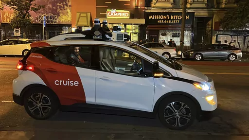 Associated Press reporter Michael Liedtke sits in the back of a Cruise driverless taxi that picked him up in San Francisco's Mission District, Feb. 15, 2023. California's Department of Motor Vehicles on Tuesday, Oct. 24, immediately suspended operation of Cruise's driverless robotaxis in San Francisco, citing public safety after one of its cars ran over a person fatally struck by a vehicle driven by a human. (AP Photo/Terry Chea, File)