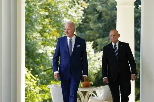 President Joe Biden walks with Bob Parant, Medicare beneficiary with Type 1 diabetes, as they arrive to speak at an event on health care costs, in the Rose Garden of the White House, Tuesday, Sept. 27, 2022, in Washington. (AP Photo/Susan Walsh)