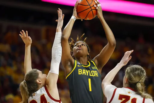 Baylor forward NaLyssa Smith (1) shoots over Iowa State guard Ashley Joens (24) and forward Morgan Kane (31) during the first half of an NCAA college basketball game Monday, Feb. 28, 2022, in Ames, Iowa. NaLyssa Smith was a unanimous choice for the Associated Press All-America team announced Wednesday, March 16, 2022.(AP Photo/Matthew Putney, File)