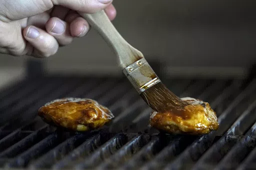 Chef Zach Tyndall prepares Good Meat's cultivated chicken at the Eat Just office in Alameda, Calif., June 14, 2023. Lab-grown meat is not currently available in any U.S. grocery stores or restaurants. If some lawmakers have their way, it never will be. (AP Photo/Jeff Chiu, File)