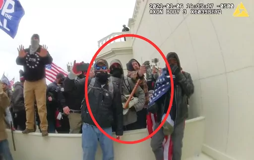 In this image from a Washington Metropolitan Police Department officer's body-worn video camera, released and annotated by the Justice Department in the Government's Sentencing Memorandum, Peter Schwartz circled in red is shown using a canister of pepper spray against officers on Jan. 6, 2021, in Washington. Schwartz on Friday, May 5, 2023, was sentenced to 14 years in prison for attacking police officers with pepper spray as he stormed the U.S. Capitol with his wife. (Justice Department via AP)