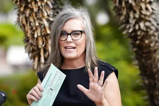 Arizona Secretary of State Katie Hobbs speaks to the media before dropping off her primary election ballot July 21, 2022, in Scottsdale, Ariz. A voter registration error caused up to 6,000 Arizona voters to get a mail ballot with only federal races, Hobbs said Tuesday, Oct. 18. Hobbs, who is the Democratic nominee for governor, said in a statement that affected voters will receive the correct ballot shortly. (AP Photo/Ross D. Franklin, File)