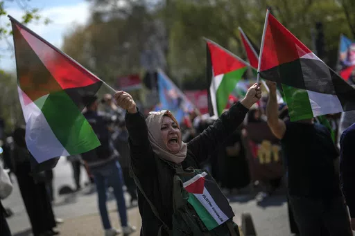 A woman waves flags in support of Palestinians in Gaza during a protest in Istanbul, Turkey, Friday, April 5, 2024. Turkey and Israel announced tit-for-tat trade barriers on Tuesday, April 9, 2024, as relations between them further deteriorated amid the war in Gaza. Turkey, a staunch critic of Israel’s military actions in Gaza, first announced that it was restricting exports of 54 types of products to Israel with immediate effect. The products include aluminum, steel, construction products, je