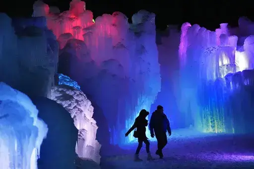 Colorful lights shine inside inside the walls of ice at Ice Castles, Friday, Jan. 10, 2025, in North Woodstock, N.H. (AP Photo/Robert F. Bukaty)