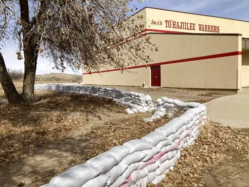 This Feb. 17, 2023 image shows a wall of sandbags protecting the school in the Navajo community of To'Hajiilee, New Mexico. To'Hajiilee Community School is just one of dozens funded by the U.S. Bureau of Indian Education that are in desperate need of repair or replacement. The agency estimates it would cost roughly $6.2 billion to address the needs of those schools in poor condition. (AP Photo/Susan Montoya Bryan)