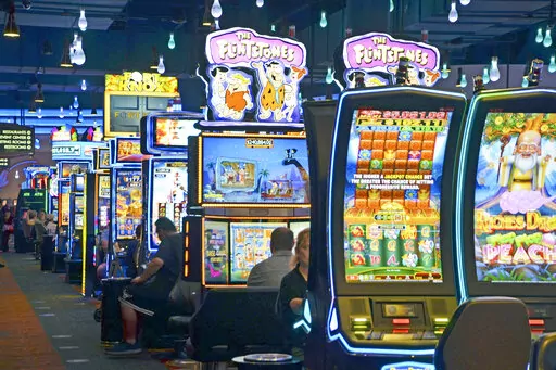 FILE — Slot machines at the FireKeepers Casino Hotel, owned and operated by the Nottawaseppi Huron Band of the Potawatomi, are seen in Battle Creek, Mich., Aug. 5, 2019. The casino shut down in the early months of COVID-19 pandemic, but the financial impact was blunted in part by the tribe's non-gambling businesses, including a firm involved in drone development for the federal government that was deemed "essential." (Nick Buckley/Battle Creek Enquirer via AP, File)