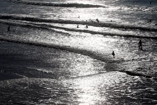 People swim in the Atlantic Ocean in Biarritz, southwestern France, Oct. 27, 2021. An abrupt shutdown of Atlantic Ocean currents that could put large parts of Europe in a deep freeze is looking a bit more likely and closer than before, according to a new story. (AP Photo/Bob Edme, File)