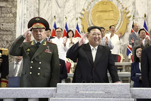 In this photo provided by the North Korean government, North Korean leader Kim Jong Un, center, Russian Defense Minister Sergei Shoigu, left, and China's Vice Chairman of the standing committee of the country's National People's Congress Li Hongzhong, right, attend a military parade to mark the 70th anniversary of the armistice that halted fighting in the 1950-53 Korean War, on Kim Il Sung Square in Pyongyang, North Korea, on July 27, 2023. Shoigu visited Pyongyang in what the U.S. saw as part o