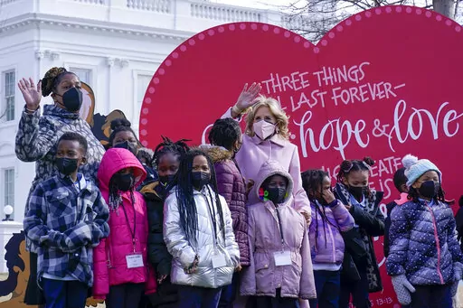 First lady Jill Biden poses for a photo with Aiton Elementary School students and staff as she welcomes school children to the White House in Washington, Monday, Feb. 14, 2022, to celebrate Valentine's Day. (AP Photo/Susan Walsh)