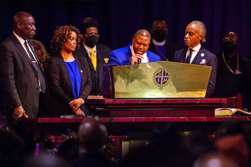 Andre Locke, Amir Locke's father, speaks during the funeral for Amir Locke at Shiloh Temple International Ministries, Thursday, Feb. 17, 2022, in Minneapolis, Minn. Locke was killed Feb. 2 by Minneapolis police as they executed a no-knock search warrant. (AP Photo/Nicole Neri)