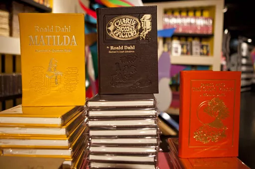 Books by Roald Dahl are displayed at the Barney's store on East 60th Street in New York on Monday, Nov. 21, 2011. Critics are accusing the publisher of Roald Dahl’s classic children’s books of censorship after it removed colorful language from stories such as “Charlie and the Chocolate Factory” and “Matilda” to make them more acceptable to modern readers. (AP Photo/Andrew Burton, File)