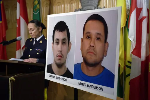 Assistant Commissioner Rhonda Blackmore speaks next to images of Damien Sanderson and Myles Sanderson during a press conference at the Royal Canadian Mounted Police "F" Division headquarters in Regina, Saskatchewan, on Sunday, Sept. 4, 2022. Police said the pair allegedly stabbed and killed multiple people in various locations between the James Smith Cree Nation and in the village of Weldon, northeast of Saskatoon, on Sunday morning, and are presently at large. (Michael Bell/The Canadian Press v