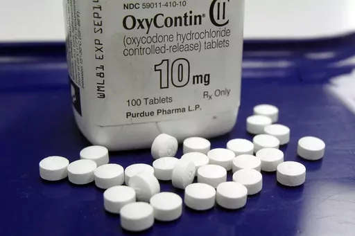 OxyContin pills are arranged for a photo at a pharmacy in Montpelier, Vt., Feb. 19, 2013. Purdue and state, local and Native American tribal governments across the U.S. agreed to settle lawsuits over the toll of opioids more than a year ago, but the money isn't flowing yet because of a wait for a key court ruling.(AP Photo/Toby Talbot, File)