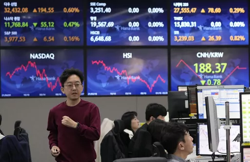 A currency trader passes by the screens showing the foreign exchange rates at the foreign exchange dealing room of the KEB Hana Bank headquarters in Seoul, South Korea, Tuesday, March 28, 2023. Asian shares were mostly higher on Tuesday as investors got some relief from worries over troubled U.S. banks with a planned takeover of failed Silicon Valley Bank.(AP Photo/Ahn Young-joon)