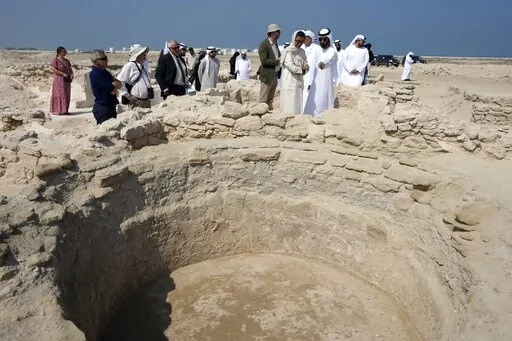 Sheikh Majid bin Saud Al Mualla, chairman of the Umm Al Quwain Department of Tourism and Archaeology, front right, explains to Noura Al Kaabi, UAE Minister of Culture and Youth, during a visit of the ancient Christian monastery on Siniyah Island in Umm al-Quwain, United Arab Emirates, Thursday, Nov. 3, 2022. The monastery possibly dating as far back as the years before Islam rose across the Arabian Peninsula has been discovered on an island off the coast of the UAE officials announced Thursday, 