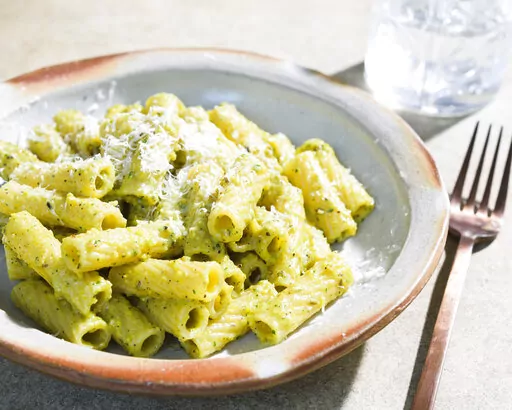 This image released by Milk Street shows a recipe for Rigatoni w/Pistachio, Ricotta and Herb Pesto. (Milk Street via AP)