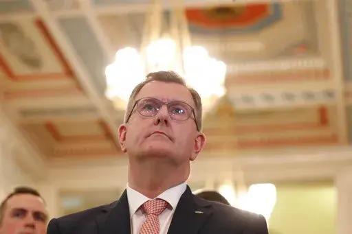 Democratic Unionist Party leader Jeffrey Donaldson pauses as he speaks to the media at Parliament Buildings, Stormont, Belfast, Monday, May 9, 2022. Britain and the European Union are once again at loggerheads over Brexit on Wednesday, May 11, 2022. The U.K. government has ramped up threats to scrap parts of its trade treaty with the bloc, saying the rules are preventing the formation of a new government in Northern Ireland.  (AP Photo/Peter Morrison, File)