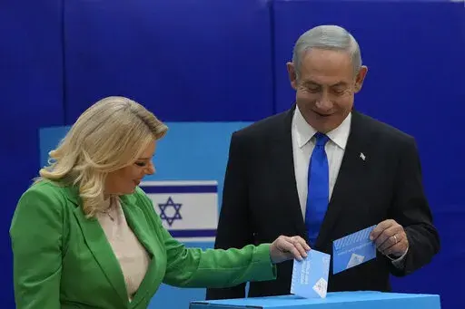 Likud party chairman Benjamin Netanyahu and his wife 'Sara cast their ballots during Israeli elections in Jerusalem, Tuesday, Nov. 1, 2022. (AP Photo/Maya Alleruzzo)