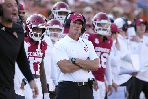 Oklahoma head football coach Brent Venables, center, watches play against Texas late in the second half of an NCAA college football game in Dallas, Saturday, Oct. 12, 2024. (AP Photo/Jeffrey McWhorter)
