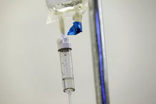 In this May 25, 2017 file photo, chemotherapy drugs are administered to a patient at a hospital in Chapel Hill, N.C. Scaling back treatment in some cancers — ovarian, esophageal and Hodgkin lymphoma — can make life easier for patients without compromising outcomes, doctors reported at the American Society of Clinical Oncology annual meeting in early June 2024. (AP Photo/Gerry Broome, File)