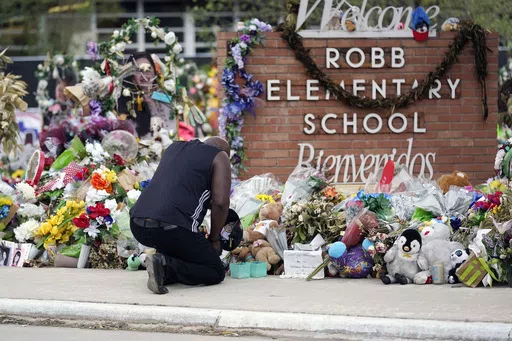 Reggie Daniels pays his respects a memorial at Robb Elementary School, Thursday, June 9, 2022, in Uvalde, Texas. The 19 fourth-graders and two teachers killed at the elementary school are being remembered, Friday, May 24, 2024 as the second anniversary of the one of the deadliest school shootings in U.S. history is marked. (AP Photo/Eric Gay)