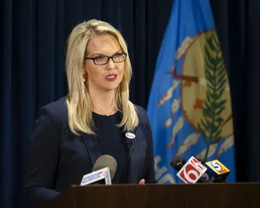 U.S. Senate candidate Abby Broyles speaks to the media at the Colcord Hotel in Oklahoma City, Tuesday, Nov. 3, 2020.  Broyles is apologizing after reports that she became intoxicated, berated several middle-school aged girls at a sleepover and vomited in a hamper.   Broyles told television station KFOR that she had an adverse reaction after drinking wine and taking medication given to her by a friend. (AP Photo/Garett Fisbeck, File)