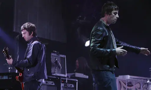 Noel, left, and Liam Gallagher, of Oasis, perform during the start of their Canadian tour in Vancouver, B.C., on Aug. 27, 2008. (Darryl Dyck/The Canadian Press via AP, File)