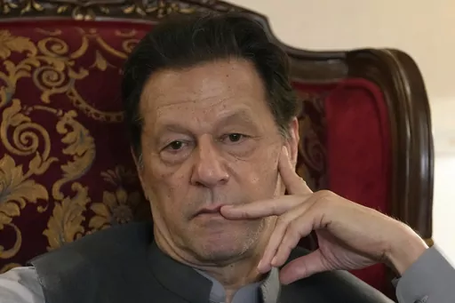 Pakistan's former prime minister Imran Khan listens to a member of the media during a talk with reporters regarding the current political situation and the ongoing cases against him at his residence in Lahore, Pakistan, on Aug. 3, 2023. A Pakistani court on Monday, Oct. 23, indicted Imran Khan on charges of revealing official secrets after his 2022 ouster from office in another slap to the former prime minister who will likely be unable to run in the upcoming parliamentary elections in late Janu