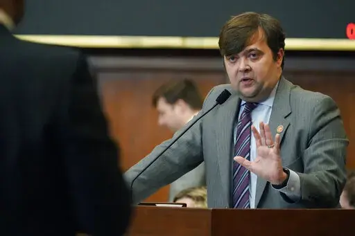 State Rep. Nick Bain, R-Corinth, right, answers a question from Rep. Edward Blackmon Jr., D-Canton, during a discussion over a transgender youth bill in the Mississippi House in Jackson, Miss., on Thursday, Jan. 19, 2023. (AP Photo/Rogelio V. Solis)