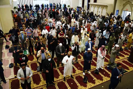 Worshippers perform an Eid al-Fitr prayer at the Masjidullah Mosque in Philadelphia, Thursday, May 13, 2021. This year, in a rare convergence, Judaism’s Passover, Christianity’s Easter and Islam’s holy month of Ramadan are interlapping in April with holy days for Buddhists, Baha’is, Sikhs, Jains and Hindus, offering different faith groups a chance to share meals and rituals in a range of interfaith events. (AP Photo/Matt Rourke, File)